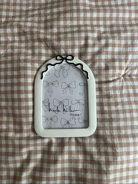 Nicole Miller Cream Arch Frame with Black Bow Trim